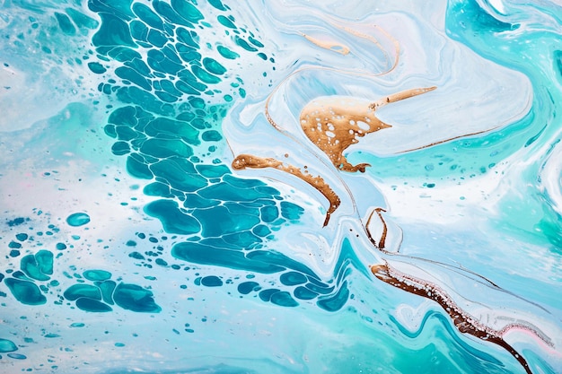 Acrylic Fluid Art Waves in mint turquoise colors with liquid golden inclusion Abstract marble background or texture