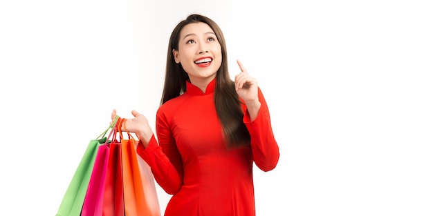 Action portrait an Asian woman wearing ao dai dress the celebration of something or lunar new year in a joyful and exuberant way