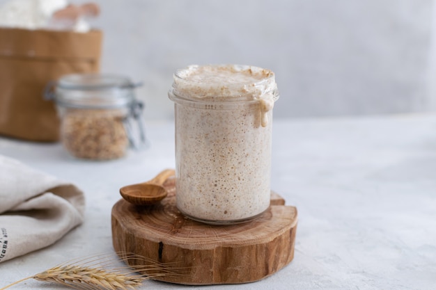 Active bubbly sourdough bread starter, healthy fermentation process on light table