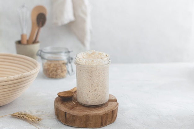 Active bubbly sourdough bread starter, healthy fermentation process on light table