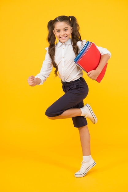 Active child in motion Beginning school lesson Keep going Active kid Hurry up Girl with books on way to school Knowledge day Back to school Kid cheerful schoolgirl running Pupil want study