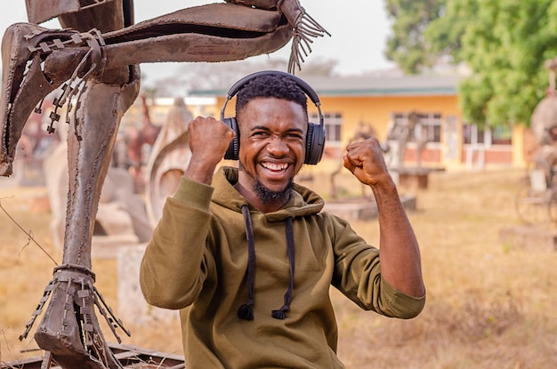 Active healthy happy African American runner listening to music with headphones