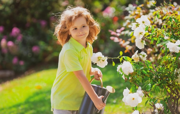 Active kid watering plants on backyard child helping arents to grow herbs and flowers ecology concept