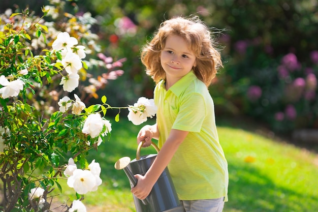 Active kid watering plants on backyard Child helping arents to grow herbs and flowers Ecology concept