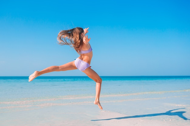 Active little girl at beach having a lot of fun.