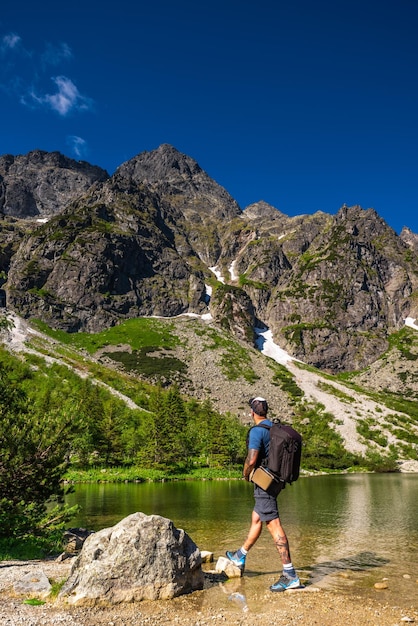 Active Man on adventure standing at lake in Tatras Mountains