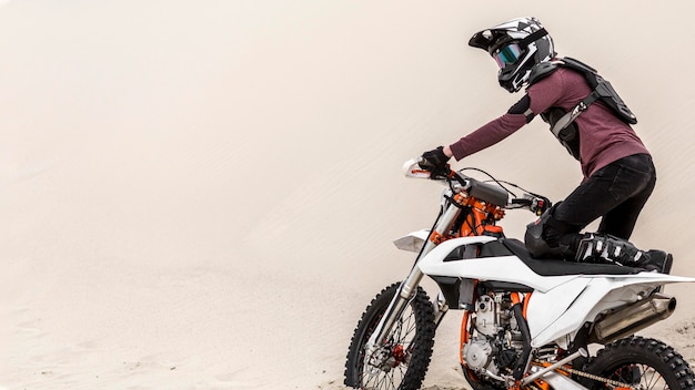 Active man riding motorbike in the desert