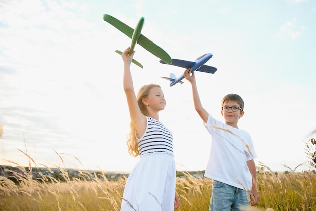 Active running kids with boy holding airplane toy