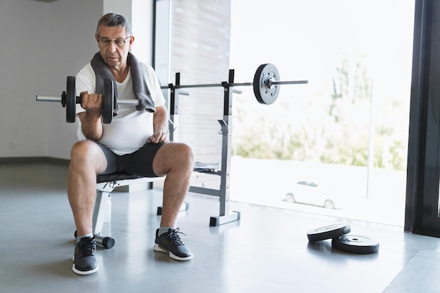 Active senior exercising in a gym