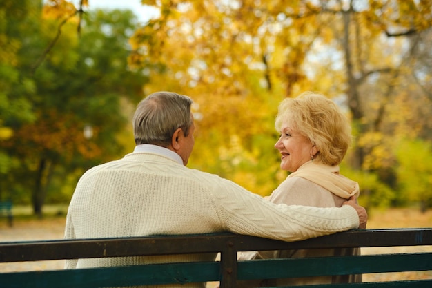 Active seniors on a walk in autumn forest