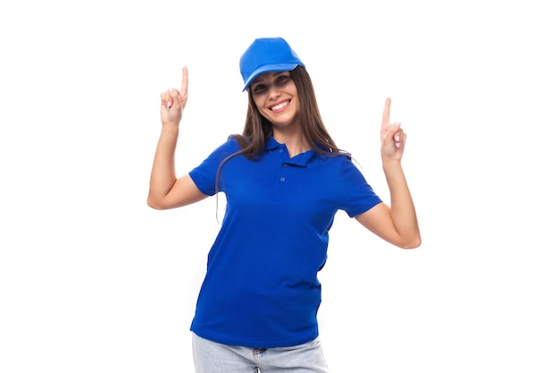 Active young brunette woman promoter in blue tshirt and cap on white background with copy space