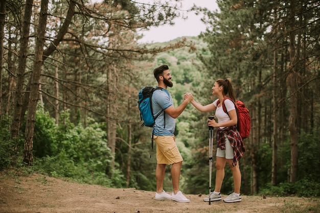 Active young hikers taking rest in mountain