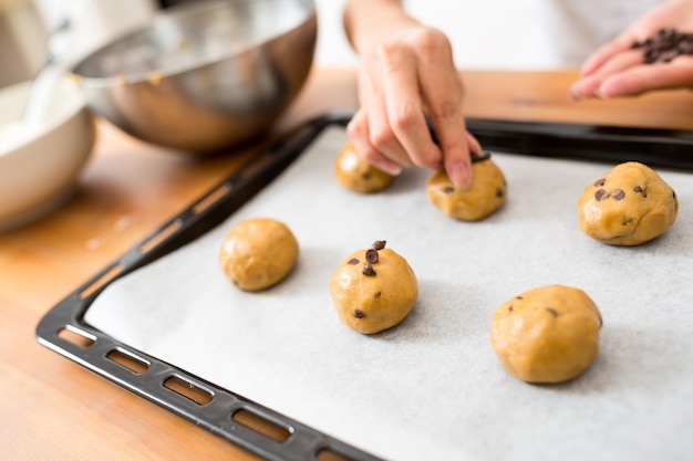 Adding chocolate chip on dough for cookies