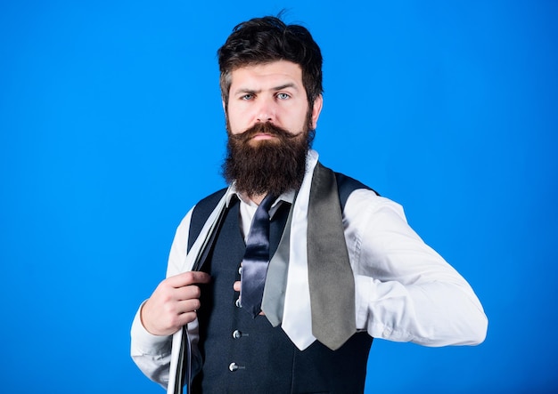 Adding a dose of class to his style of dress Man of fashion Brutal caucasian man with fashion mens accessories Man with long beard and moustache in classic style Bearded man trying on a necktie