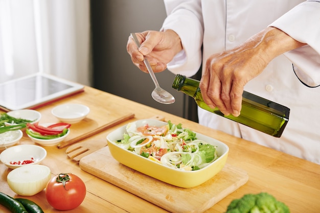 Adding oilive oil in salad