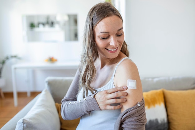 Adhesive bandage on arm after injection vaccine or medicine,ADHESIVE BANDAGES PLASTER - Medical Equipment,Soft focus Adhesive bandage on a Pregnant female brachium after covid-19 vaccination