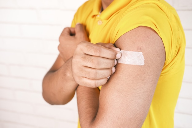 Adhesive bandage on young mans arm