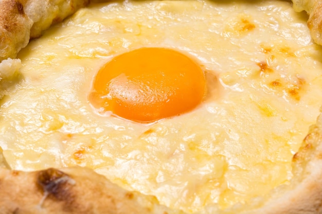 Adjarian Khachapuri closeup Georgian national food Focus on the yolk