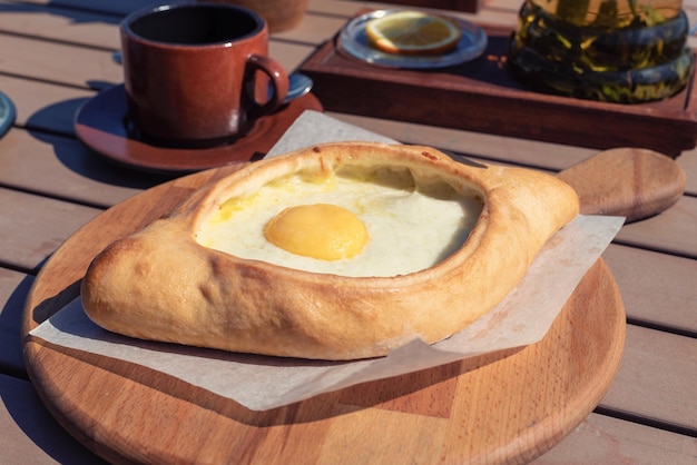 Adjarian khachapuri on a wooden board traditional Georgian cuisine