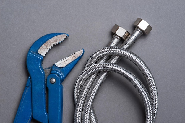 Photo adjustable spanner and braided stainless steel water hose