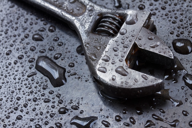 Adjustable spanner in water drops close up