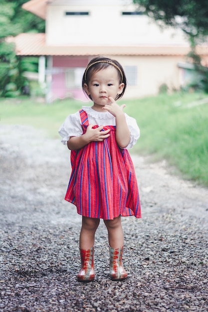 Adorable Asian Girl walking and enjoy in garden outdoor