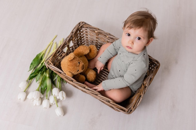 adorable baby in basket with flowers white tulips card banner space for text