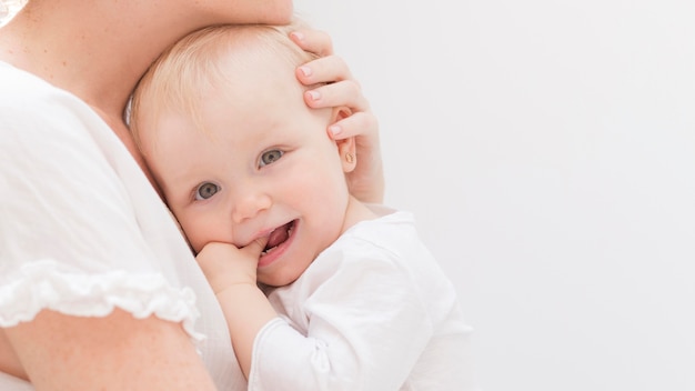 Adorable baby girl together with her mother