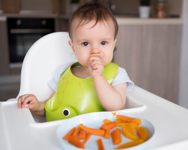 Adorable baby playing with food