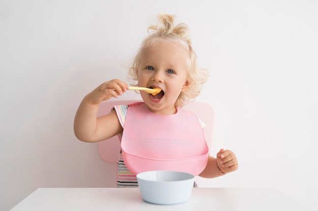 Adorable baby playing with food