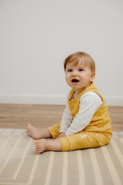 Adorable baby sitting on floor baby portrait