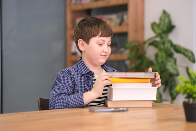 Adorable child boy sitting in a book store reading books