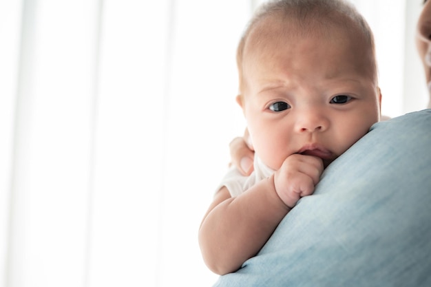 Adorable cute daughter baby girl on father shoulder