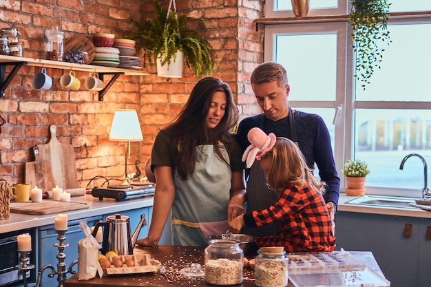 Adorable family together cooking breakfast in loft style kitchen.