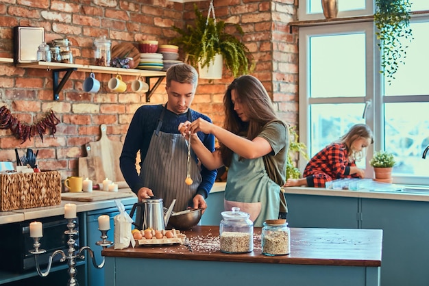 Adorable family together cooking breakfast in loft style kitchen.