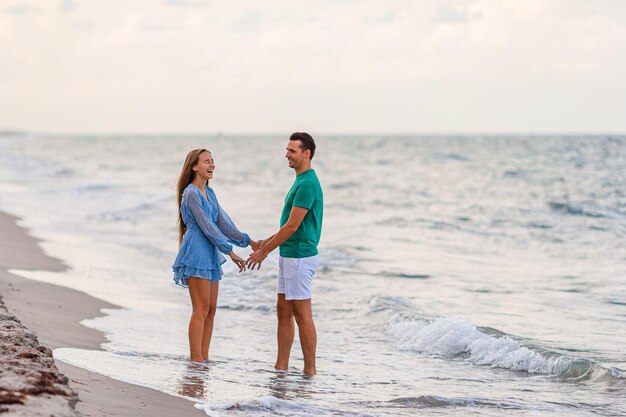 Adorable girl and happy dad having fun during beach vacation