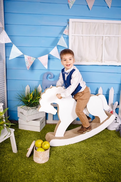 Adorable happy blond little kid boy celebrating his birthday