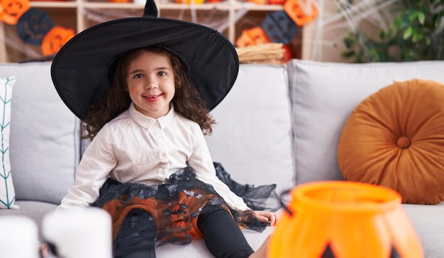 Adorable hispanic girl smiling confident wearing halloween costume at home