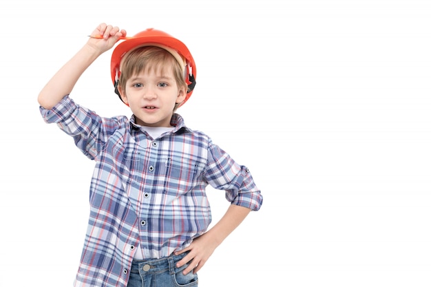 Adorable kid dressed as foreman in orange helmet and shirt 