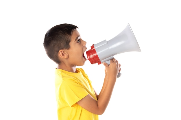 Adorable latin boy weraring a yellow t-shirt with a speaking with a megaphone isolated on a white background