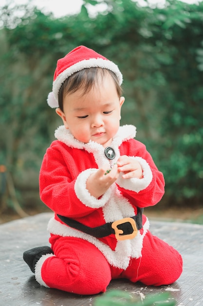 Adorable little baby in Santa Claus outfit