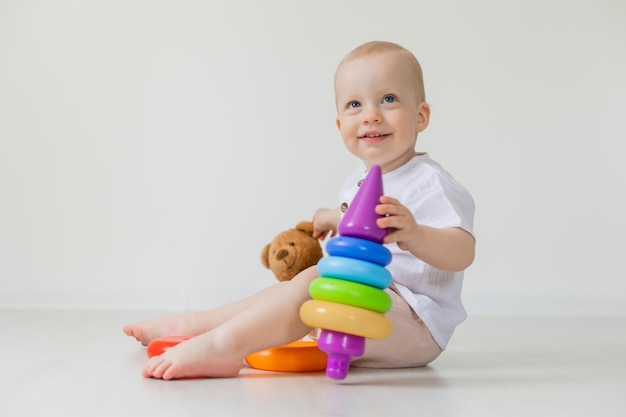 adorable little boy playing with teddy bear on floor, toys, health, banner, card, space for text