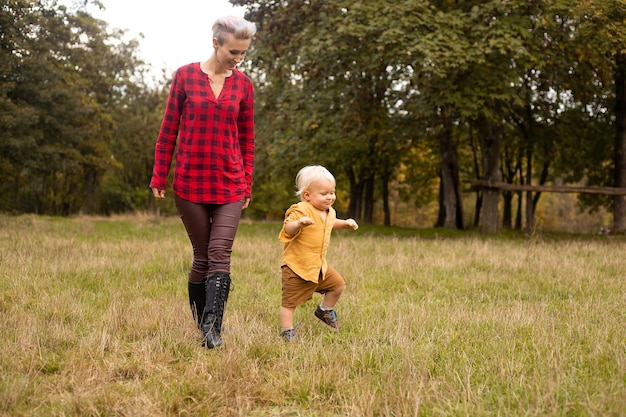 An adorable little boy with his mother in autumn park