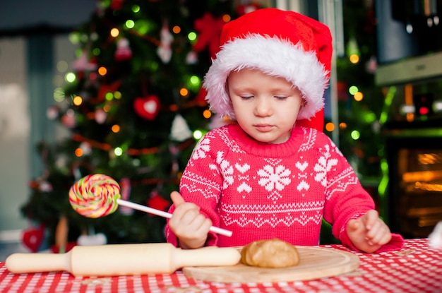 Adorable little girl baking Christmas gingerbread cookies