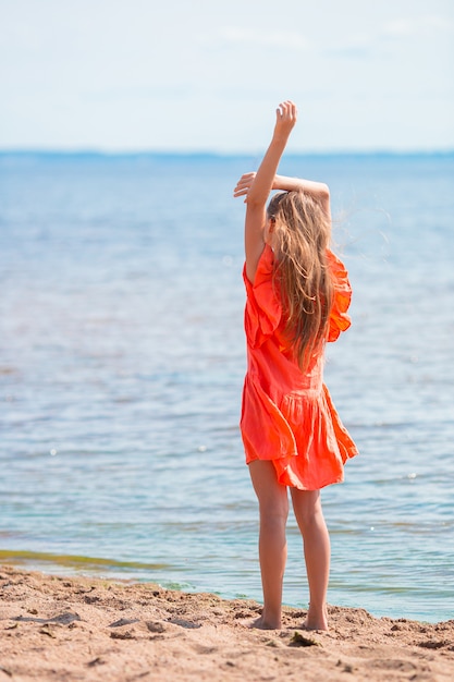 Adorable little girl at beach during summer vacation