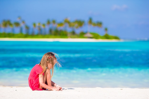 Adorable little girl at beach during summer vacation