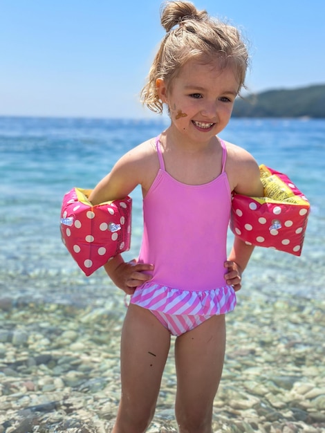 Adorable little girl at beach during summer vacation