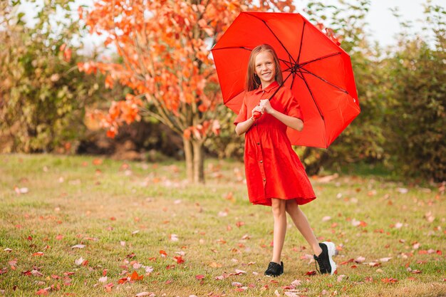 Adorable little girl at beautiful autumn day outdoors