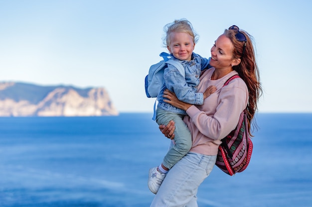 Adorable little girl and happy mother on summer vacation