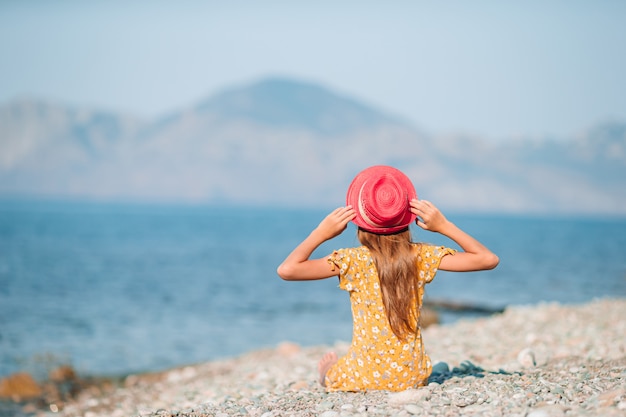 Adorable little girl have fun at tropical beach during vacation